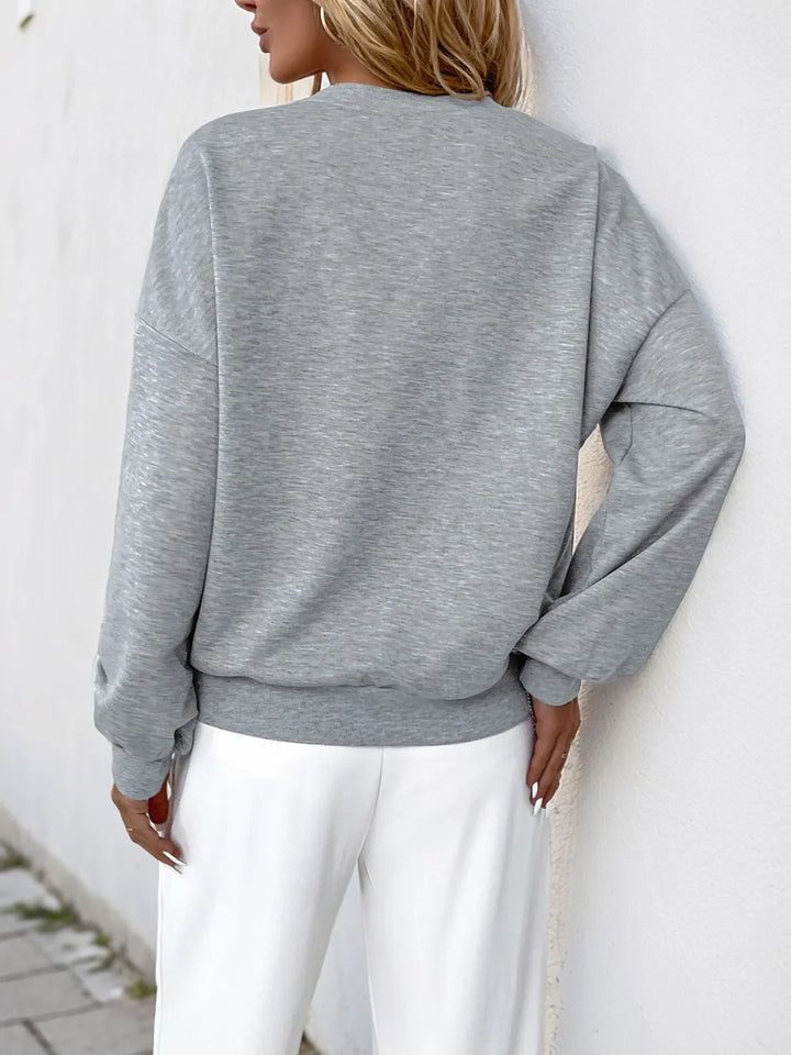 Perfee Cutout Pearl Round Neck Long Sleeve Sweatshirt.