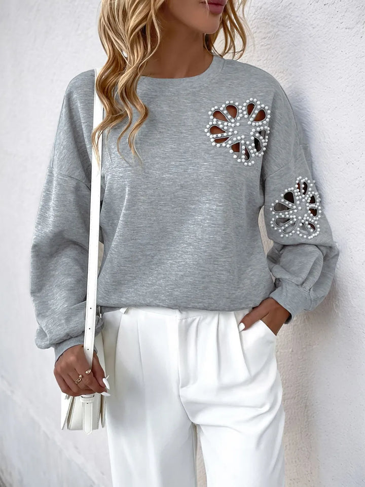 Perfee Cutout Pearl Round Neck Long Sleeve Sweatshirt.